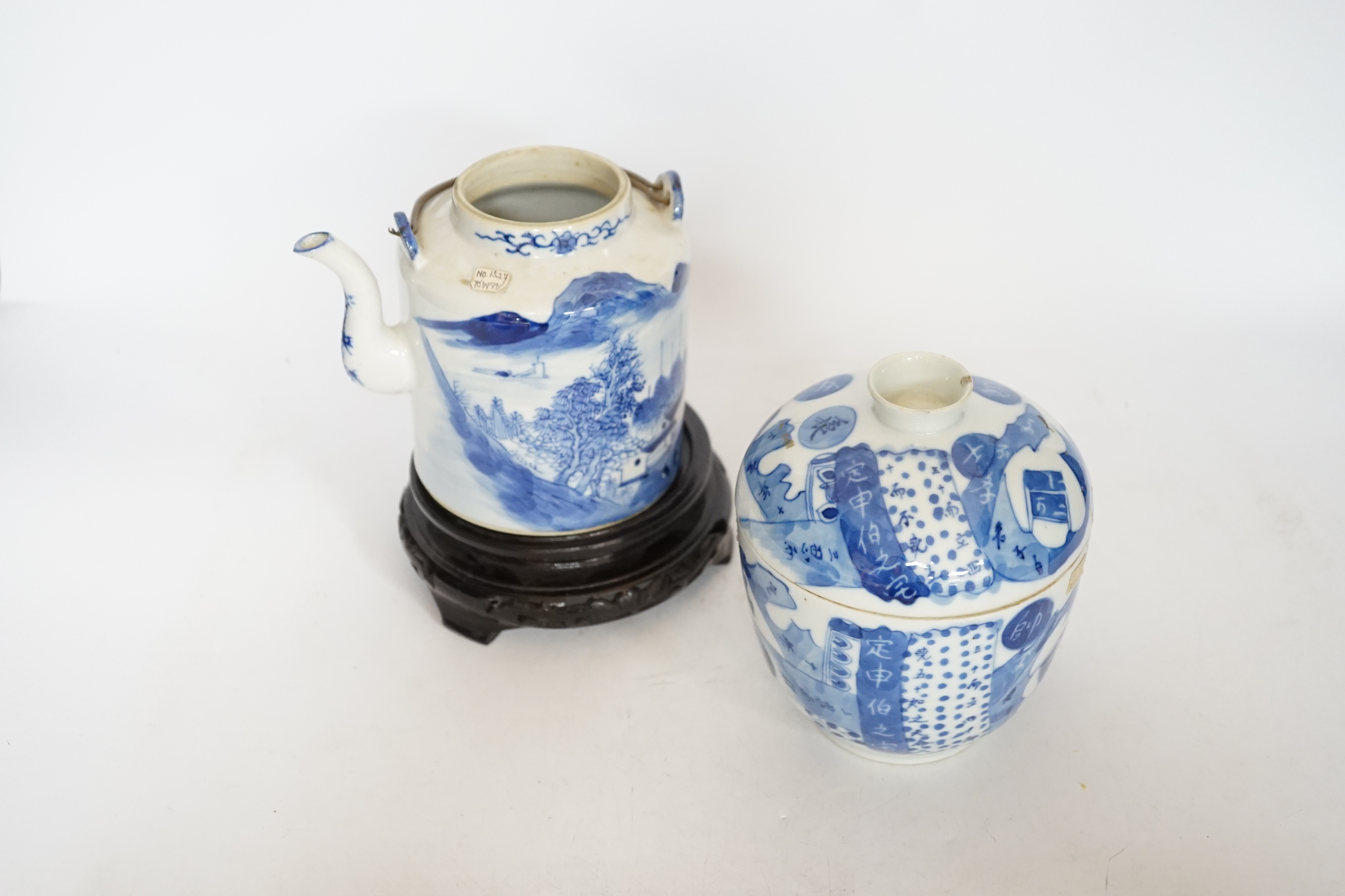 A Chinese Straits blue and white jar and cover, 19th century, a cylindrical teapot and an associated hardwood stand, largest 15cm high